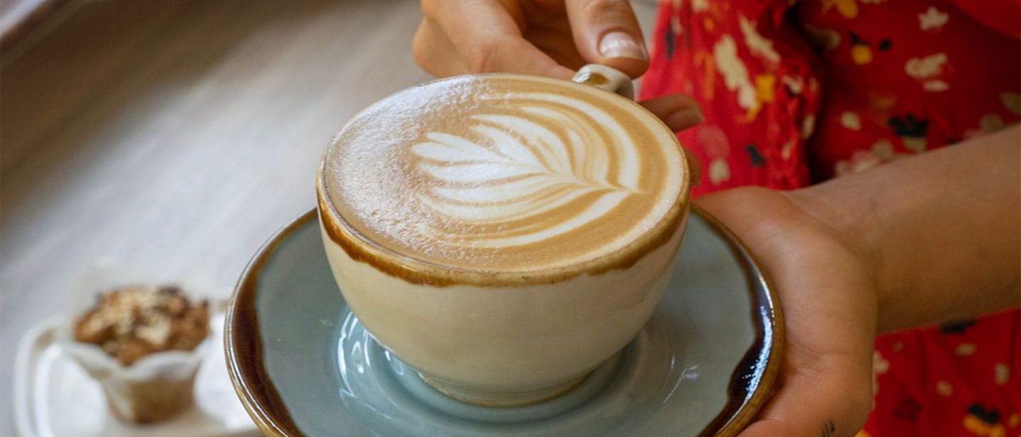 Mug with coffee and milk foam with a heart
