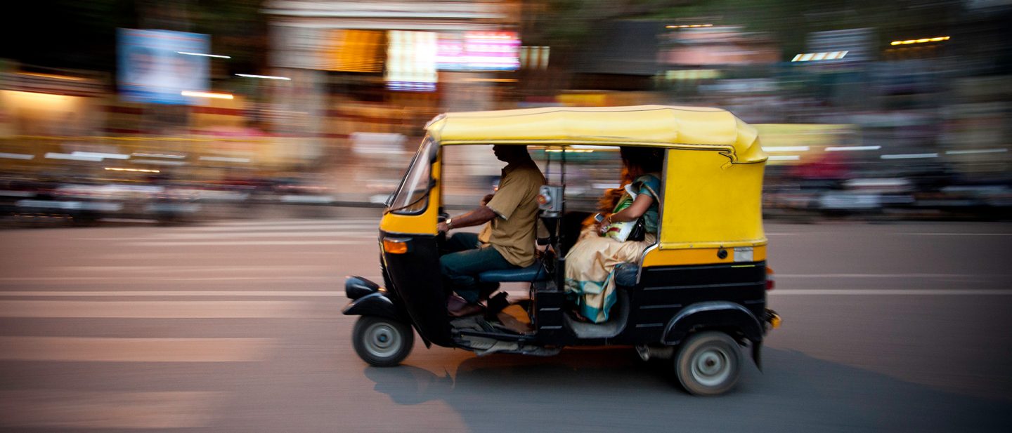 Picture of a tuk-tuk being driven.