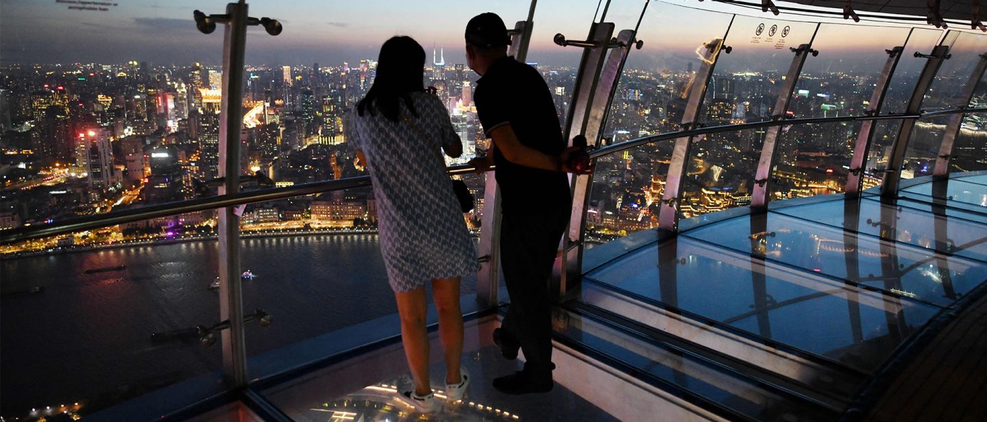 Two people on an observation deck of the Oriental Pearl Tower