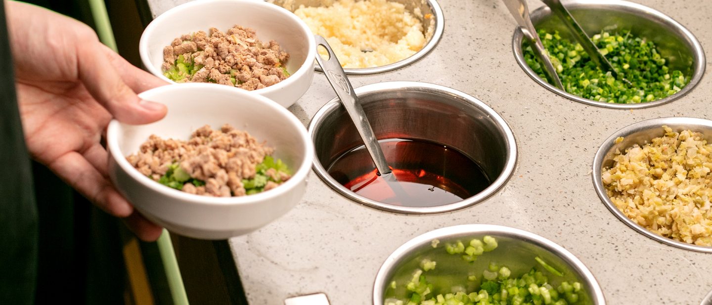 Photo of various ingredients in small bowls for a Chinese hot pot