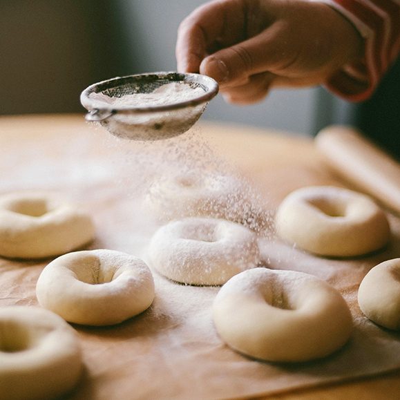 Donuts are dusted with flour