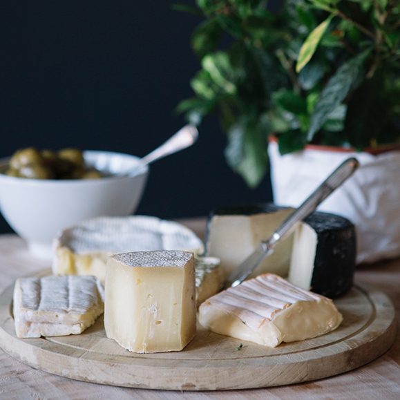 Selection of cheeses on wooden boards