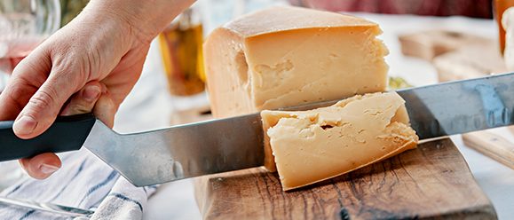 Close-up of a large cheese knife that cuts cheese