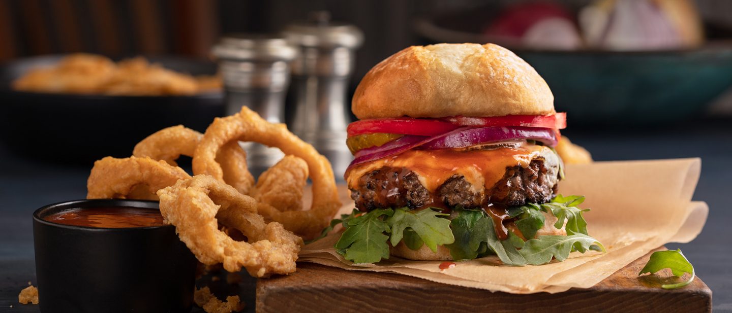 Close-up of a burger and onion rings