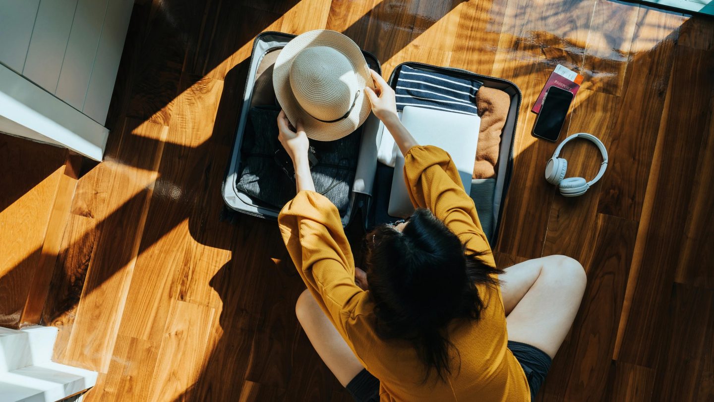 Woman packing a suitcase.