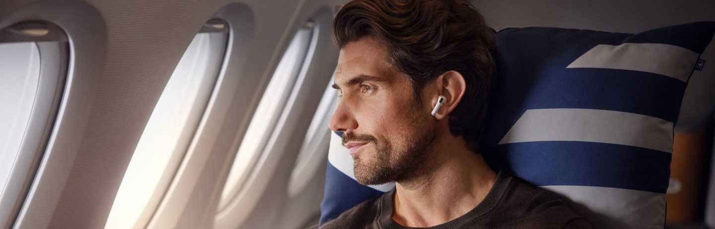 Man with AirPods sitting in the aircraft.