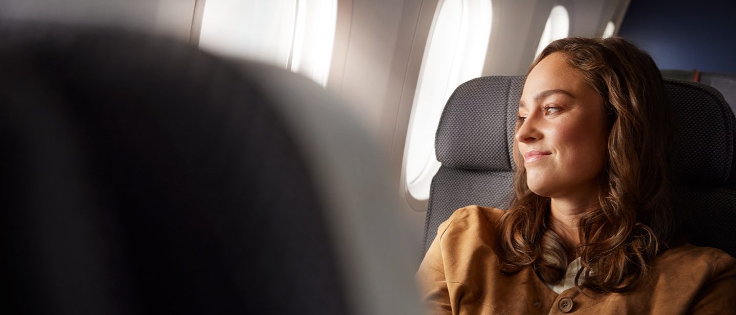 A well-prepared female passenger sits in her seat.