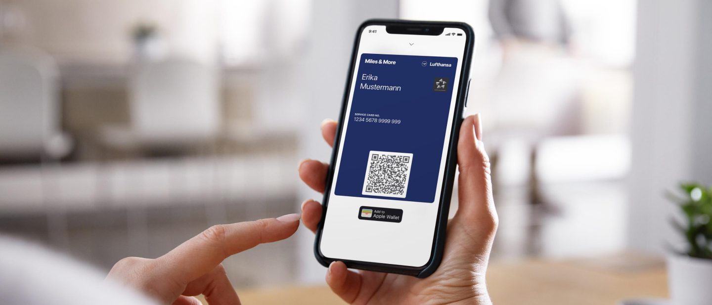 Person with smartphone in their hand. They have opened the information on their Miles & More account.