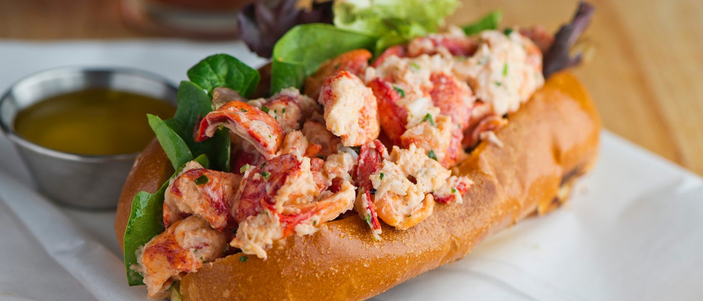 Close-up of a lobster roll in a toasted bun served on a plate