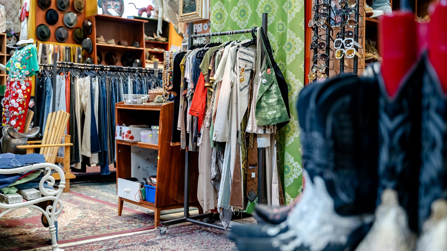 A vintage clothing store in Budapest with clothing racks and shelves full of accessories