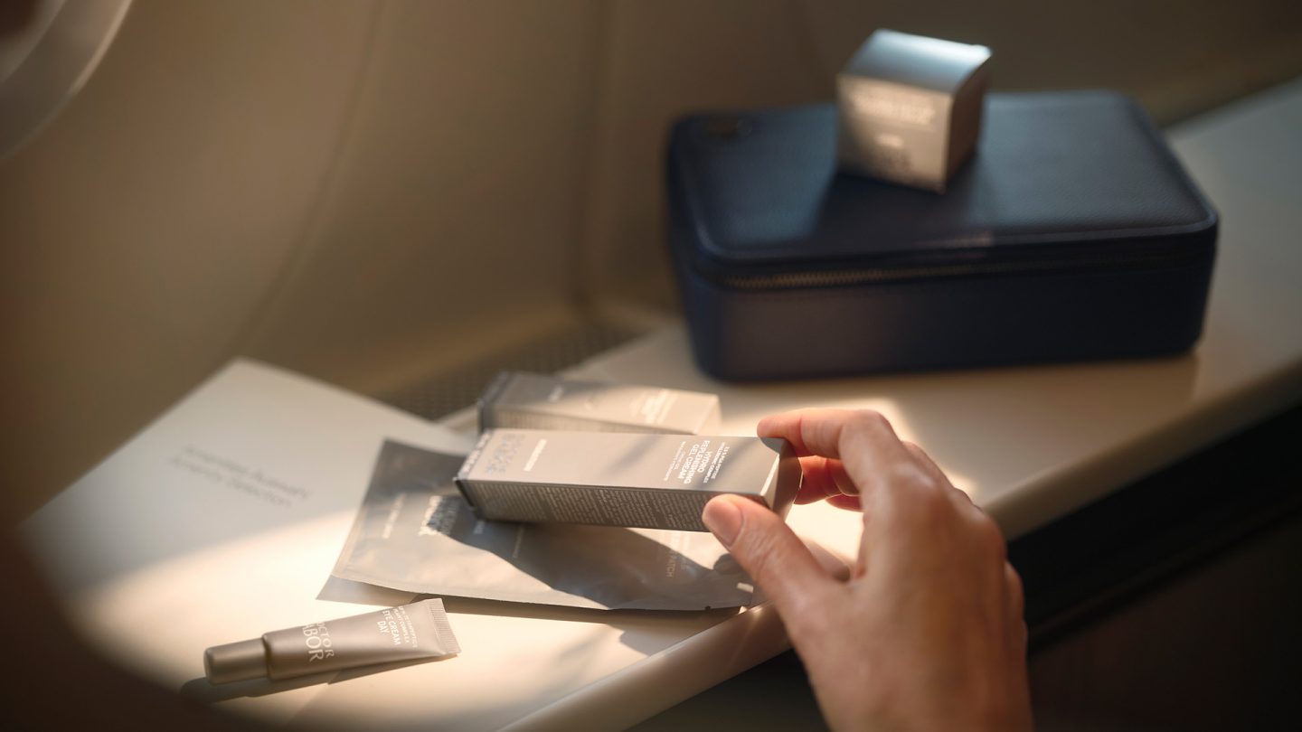 Toiletries and travel kit in first class on a table.